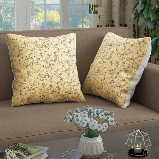 "Elegant gold-patterned Story@Home throw pillows on a cozy sofa, accentuating home comfort."