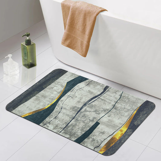 A decorative bath mat with abstract patterns in gray, blue, and yellow, placed near a bathtub.