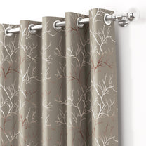 Ivory and copper branches pattern blackout curtains in taupe color, hanging on silver curtain rod with grommets