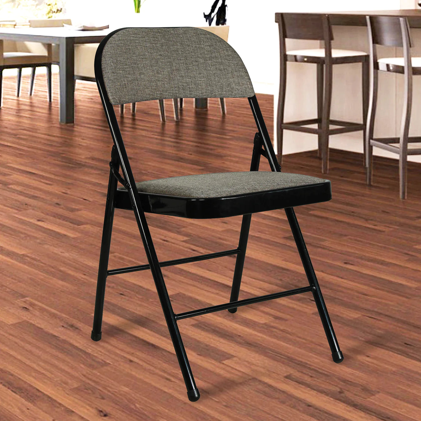 A black folding chair with a woven seat and backrest on a wooden floor.