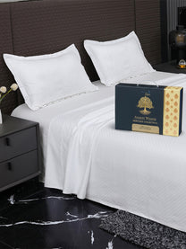 Bedsheet on bed with Ancient Weaves gift box