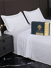 Bedsheet on bed with Ancient Weaves gift box