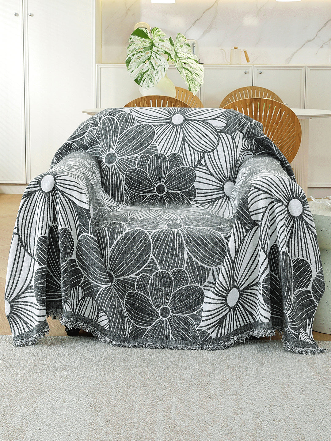 Charcoal Grey Floral throw on a single seater sofa