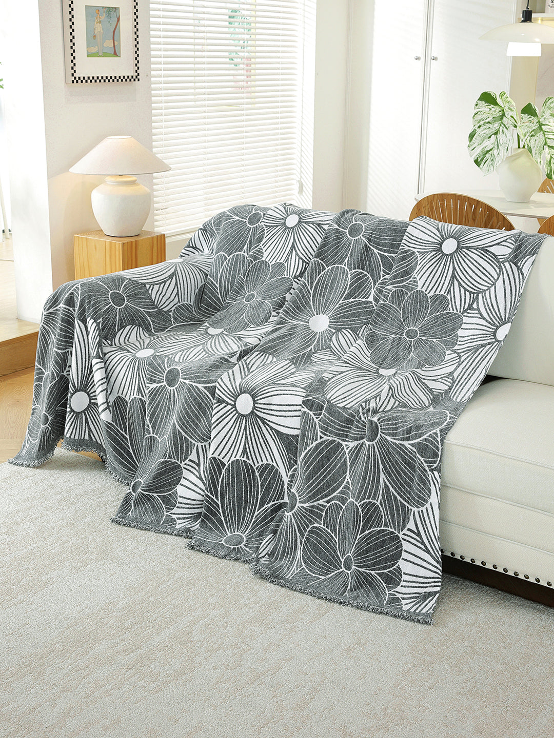 Charcoal Grey Floral throw draped on a sofa