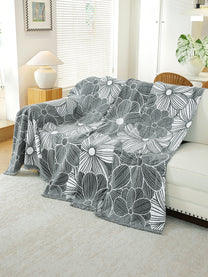 Charcoal Grey Floral throw draped on a sofa