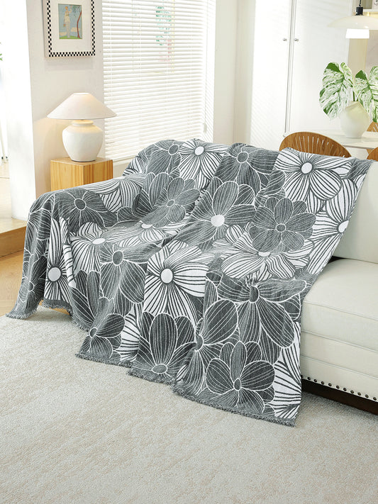 Charcoal Grey Floral throw draped on a sofa
