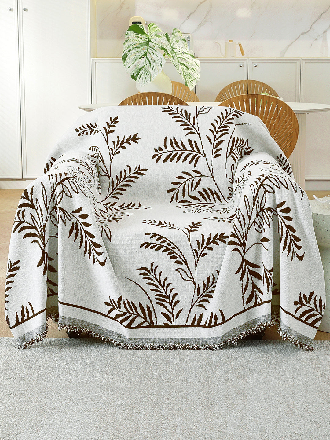Ivory & Brown Leaf throw on a single seater sofa