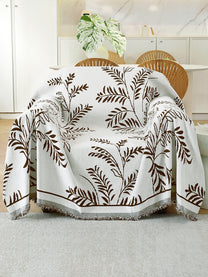 Ivory & Brown Leaf throw on a single seater sofa