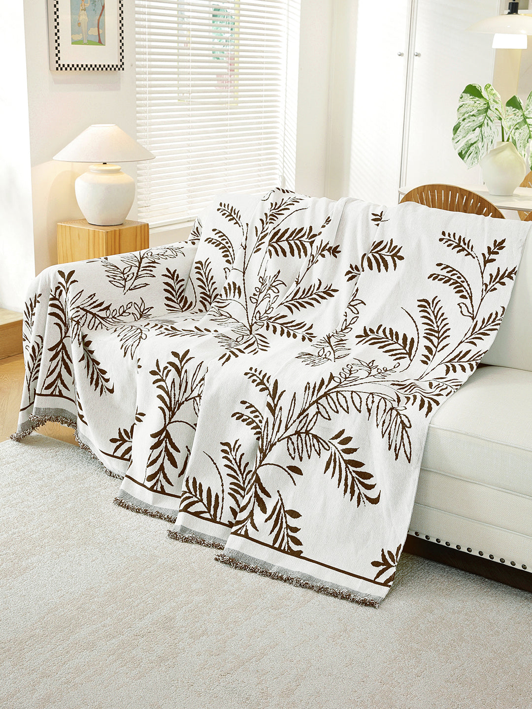 Ivory & Brown Leaf throw draped on a sofa
