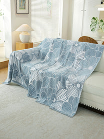 Powder Blue Floral throw draped on a sofa