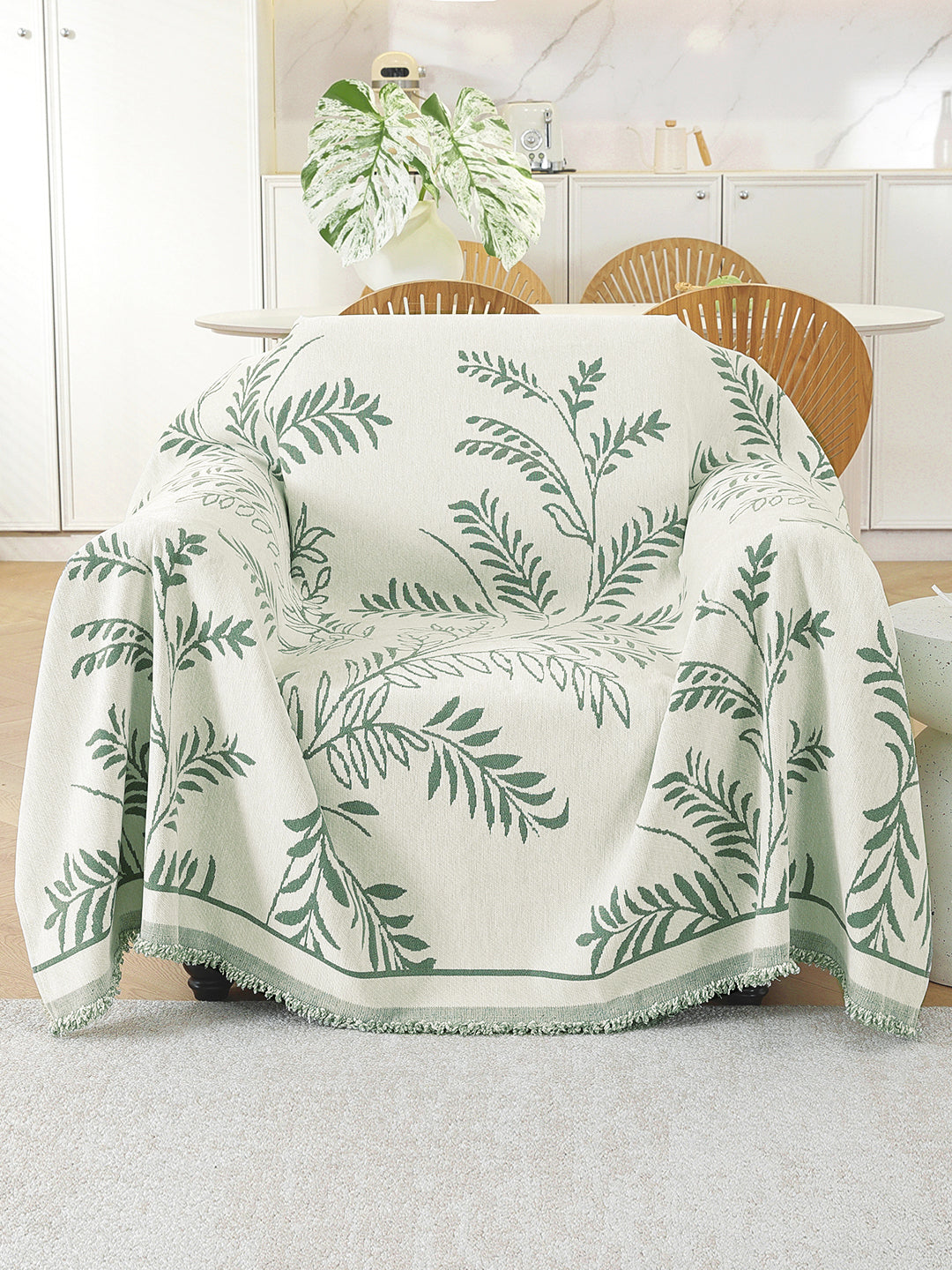 Sage Green Leaf throw on a single seater sofa
