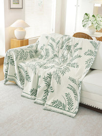 Sage Green Leaf throw draped on a sofa
