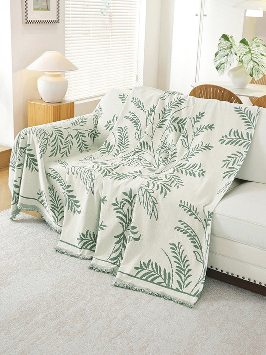 Sage Green Leaf throw draped on a sofa
