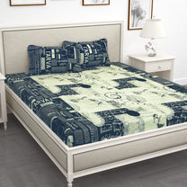 210 TC blue newspaper print king size bedsheet set displayed on a bed, showcasing its vibrant design and full coverage.